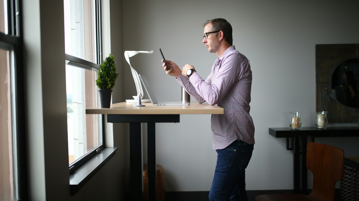 Bright workspace featuring window positioning and LED task lighting